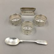 Three silver napkin rings and a silver ''Artist's Rifles'' spoon (109 grammes total weight)