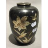 An Oriental brass vase with white metal overlay,