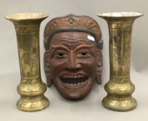 A pair of Eastern engraved brass vases together with an Eastern carved wood mask with wax seal