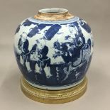 A 19th century Chinese blue and white ginger jar on a gilt bronze stand