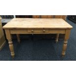 A modern pine kitchen table with a single drawer