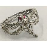 A marcasite set unmarked silver bracelet decorated with a dragonfly