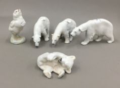 Four Royal Copenhagen porcelain polar bear figures and a bird figure