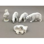 Four Royal Copenhagen porcelain polar bear figures and a bird figure