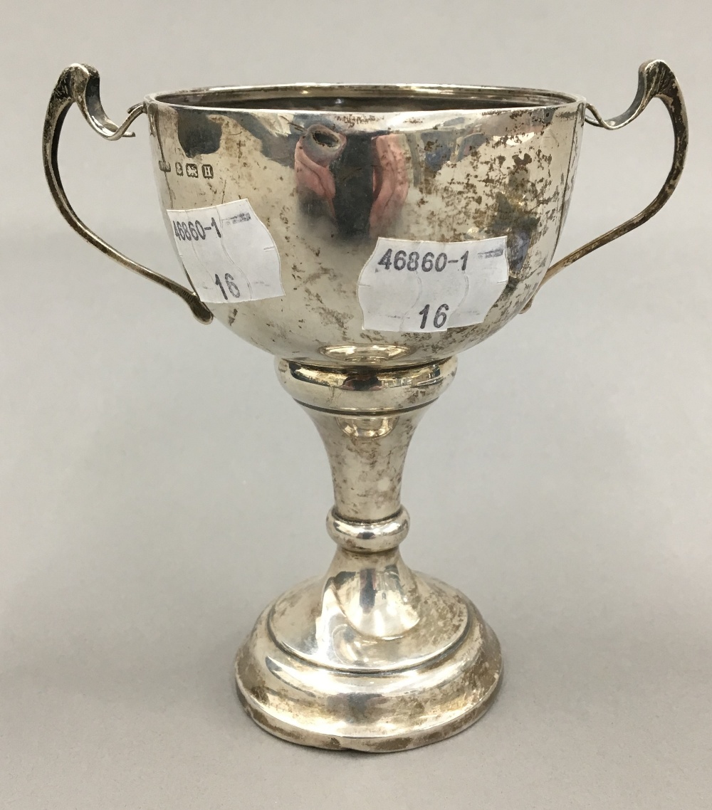 A small silver trophy cup