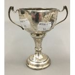 A small silver trophy cup