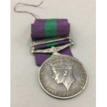 A military service medal with Palestine 1945-48 bar, awarded to 19016608 TPR. H. CHAMP.17/21.