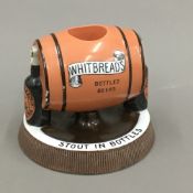 A vintage Whitbread's advertising porcelain match striker