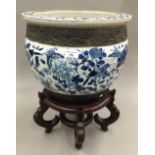 A Chinese crackle glazed jardiniere on a wooden stand
