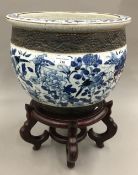 A Chinese crackle glazed jardiniere on a wooden stand