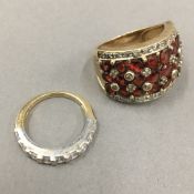 A 10 K gold redstone and diamond ring (9.4 grammes) and a 14 K gold half eternity ring (2.