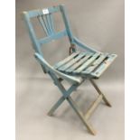 A vintage blue painted child's folding chair