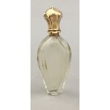 A gold topped scent bottle