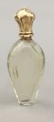 A gold topped scent bottle