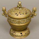 A Chinese bronze censer on stand The pierced removable lid with dog-of-fo finial,