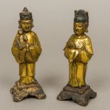 A pair of Chinese Ming gilt bronze models of attendants One male modelled in flowing robes holding