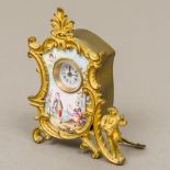 A late 19th century Continental enamel decorated gilt bronze desk clock The white enamelled dial
