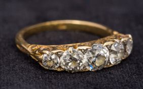 An 18 ct gold and diamond five stone ring Set with scroll pierced shoulders,