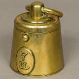 A Victorian brass novelty inkwell Formed as a 7lb weight,
