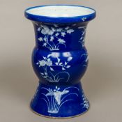 A 19th century Chinese blue and white Gu vase Decorated in the round with white floral sprays on a