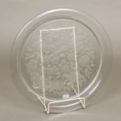 A Lalique glass charger Of dished form, with relief moulded floral scrolls, signed. 39.