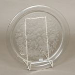 A Lalique glass charger Of dished form, with relief moulded floral scrolls, signed. 39.