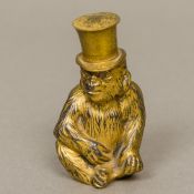 A late 19th century German gilded metal lighter Formed as a monkey wearing a removable top hat,