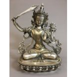 A Sino-Tibetan white metal deity Typically worked seated on a lotus plinth. 21.5 cm high.