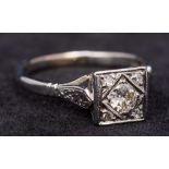 An Art Deco 18 ct white gold and platinum diamond ring The centrally set stone flanked by four