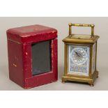 A 19th century porcelain mounted lacquered brass cased repeating carriage clock The porcelain dial