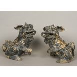 A pair of Chinese painted terracotta dogs-of-fo Each typically modelled seated with one paw raised,