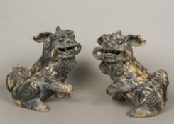 A pair of Chinese painted terracotta dogs-of-fo Each typically modelled seated with one paw raised,