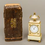 A 19th century ivory cased miniature desk clock Of stepped rectangular form surmounted with an urn,