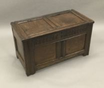 An 18th century oak two panelled coffer The panelled hinged rectangular top above the carved frieze