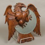 A 19th century Black Forest carved wooden wall glass Modelled as an eagle encompassing the bevelled