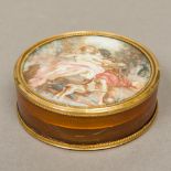 An early 19th century unmarked gold mounted blonde tortoiseshell snuff box Of circular section,