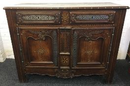 An 18th century French polished steel and brass mounted inlaid chestnut buffet The moulded