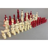 Two 19th century ivory chess sets Each of turned form. The largest king 10 cm high.