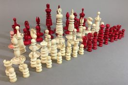 Two 19th century ivory chess sets Each of turned form. The largest king 10 cm high.