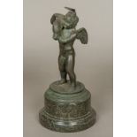 After the Antique Cupid Carrying a Dolphin Bronze, standing on a turned marble plinth base.