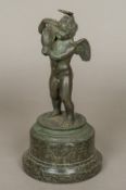 After the Antique Cupid Carrying a Dolphin Bronze, standing on a turned marble plinth base.