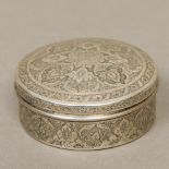 A 19th century Persian silver box With domed removable lid, decorated with scrolling floral motifs.