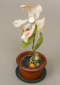 An early 20th century novelty desk clock The clock face formed as the centre of a flower protruding