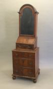 A Queen Anne style walnut domed topped bureau bookcase The moulded shaped top above the mirrored