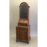 A Queen Anne style walnut domed topped bureau bookcase The moulded shaped top above the mirrored