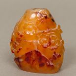 A Chinese carved agate snuff bottle Carved with floral sprays issuing from rockwork. 7 cm high.