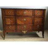A 19th century Continental gilt metal mounted kingwood marble topped commode chest The shaped black