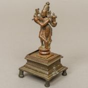 An antique Indian bronze Vishnu Modelled playing a venu,