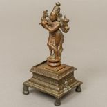 An antique Indian bronze Vishnu Modelled playing a venu,