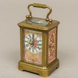 A miniature brass cased carriage clock Set with painted porcelain panels,